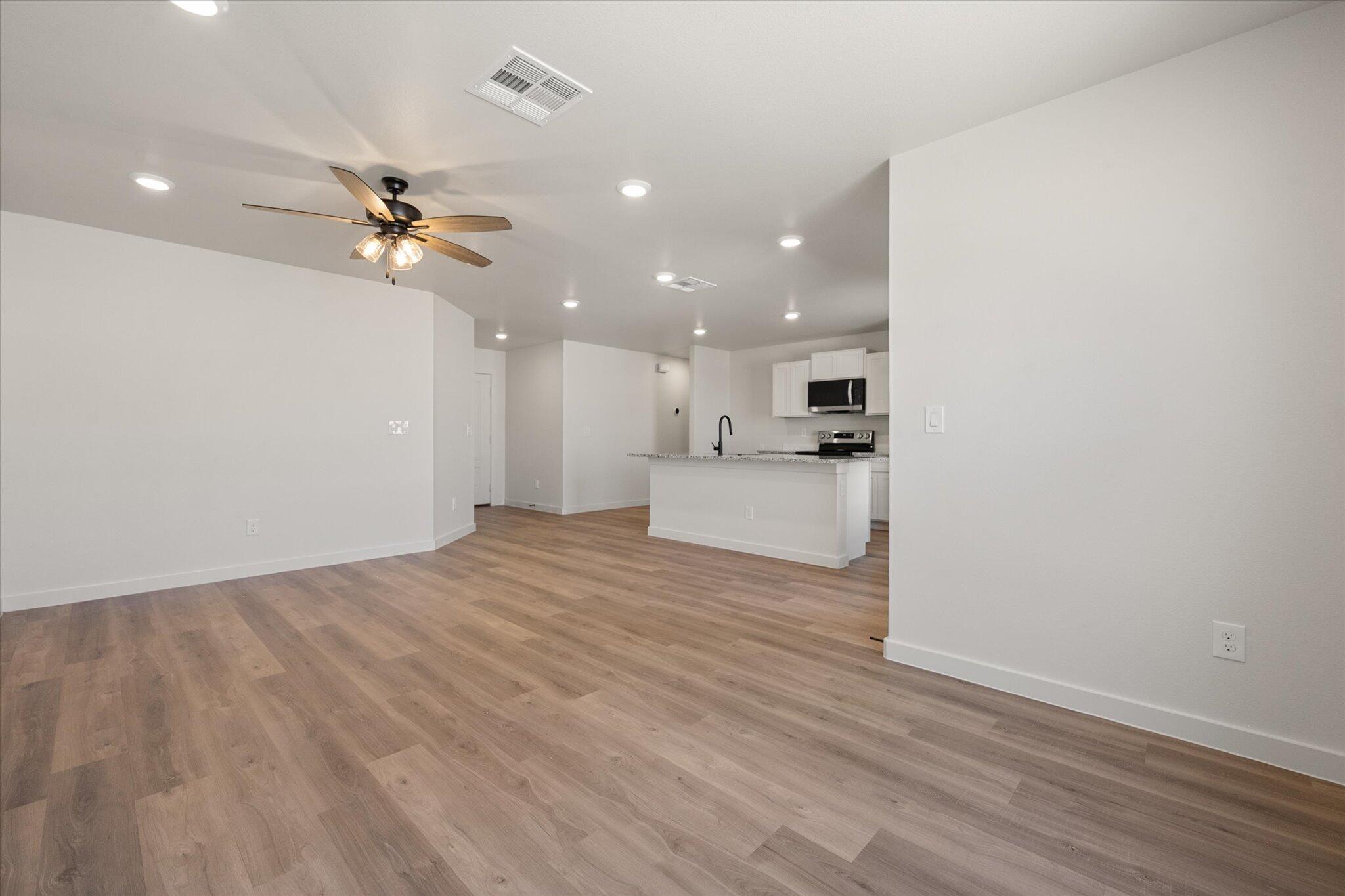 8316 24th Street Lubbock, TX 79407 - Photo 11 of 22 a view of a kitchen with a sink and wooden floor
