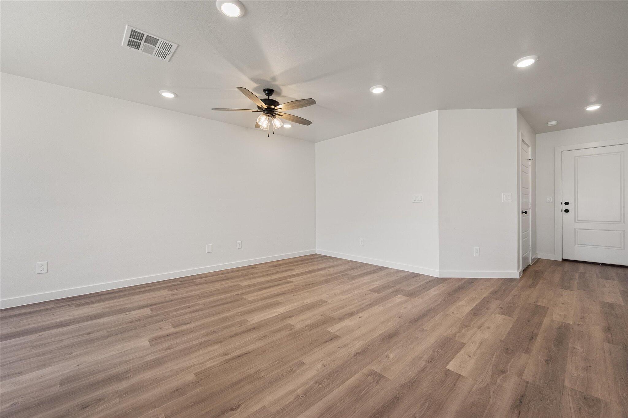 8316 24th Street Lubbock, TX 79407 - Photo 12 of 22 a view of empty room with wooden floor and ceiling fan
