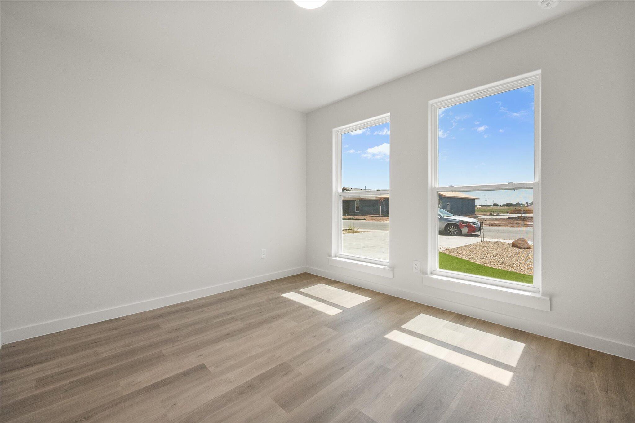 8316 24th Street Lubbock, TX 79407 - Photo 18 of 22 wooden floor in an empty room with a window