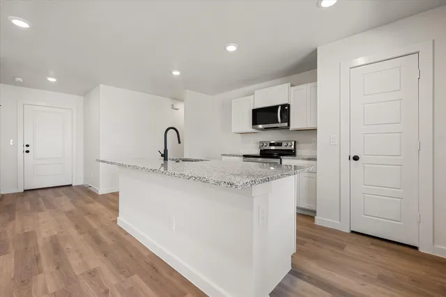 a kitchen with a sink and a stove top oven