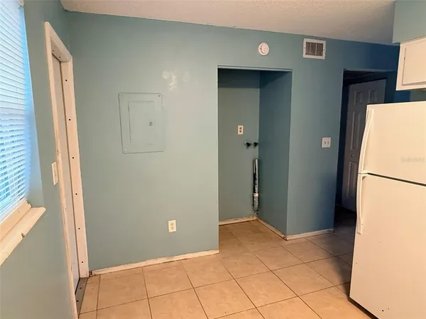 a view of a kitchen from a hallway