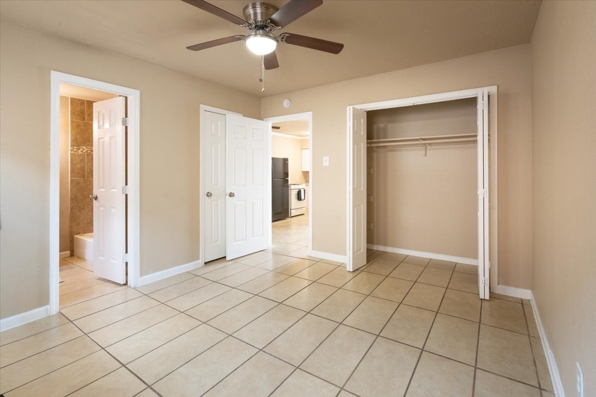 3045 Golfcrest Boulevard, Unit 10 Houston, TX 77087 - Photo 3 of 7 an empty room with closet and a chandelier fan