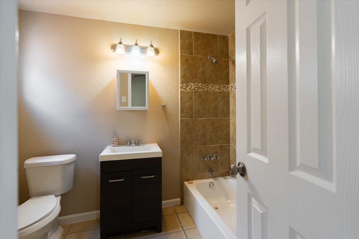 3045 Golfcrest Boulevard, Unit 10 Houston, TX 77087 - Photo 4 of 7 a bathroom with a sink a toilet and shower