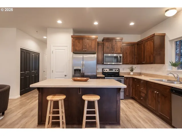 a kitchen with cabinets a sink a counter space stainless steel appliances and cabinets