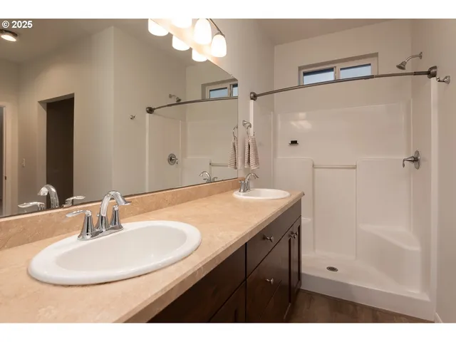 a bathroom with a sink double vanity and a mirror