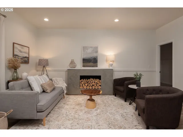 a living room with furniture and a fireplace