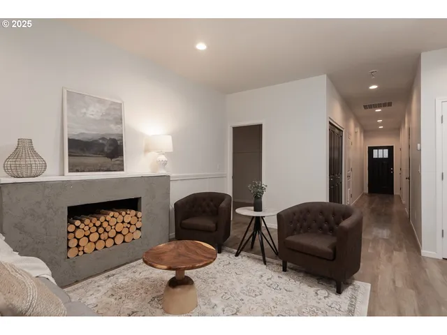 a living room with furniture a rug and a fireplace