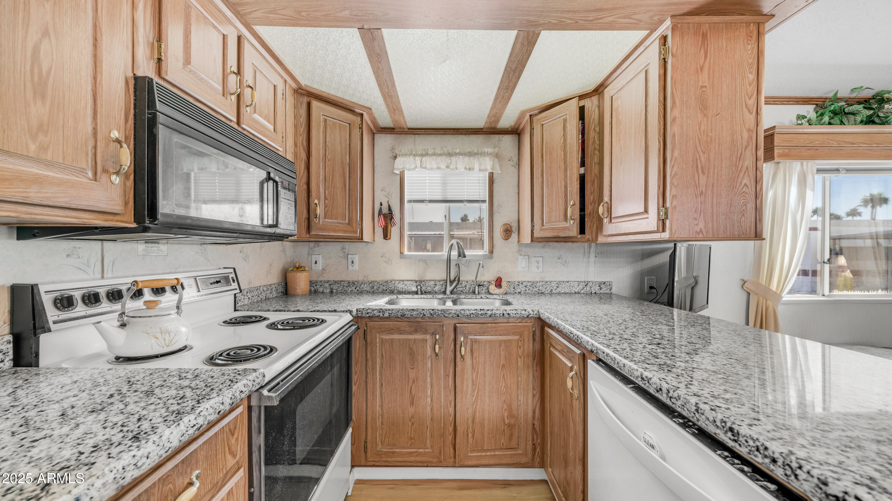 a kitchen with stainless steel appliances granite countertop a sink stove and cabinets