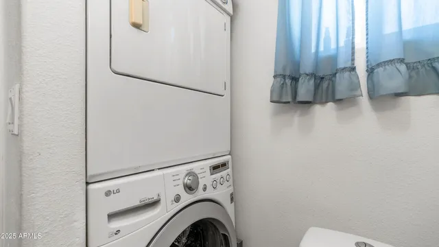 a kitchen with granite countertop a sink appliances cabinets and furniture