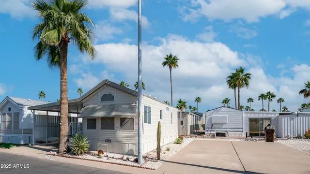 a front view of multiple houses with a yard