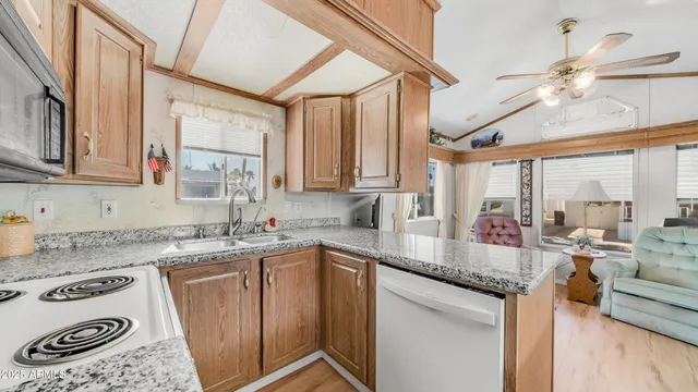 a kitchen with stainless steel appliances granite countertop a stove refrigerator sink and cabinets