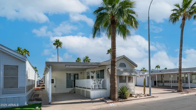 a front view of a house with a palm tree