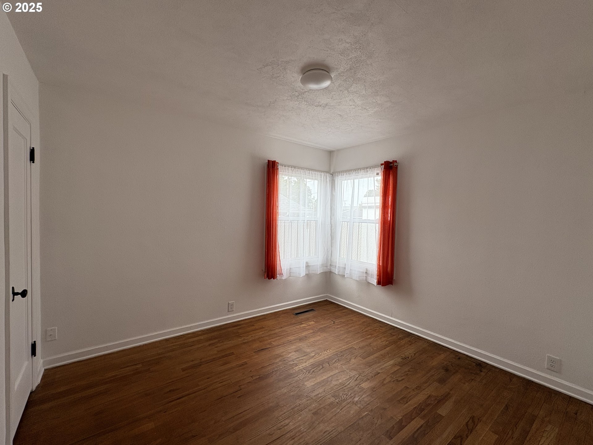 1510 Northwest Broadway Street Albany, OR 97321 - Photo 24 of 32 an empty room with wooden floor and windows