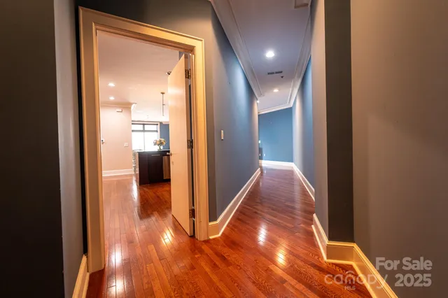 a view of kitchen with stainless steel appliances granite countertop wooden floors and a sink