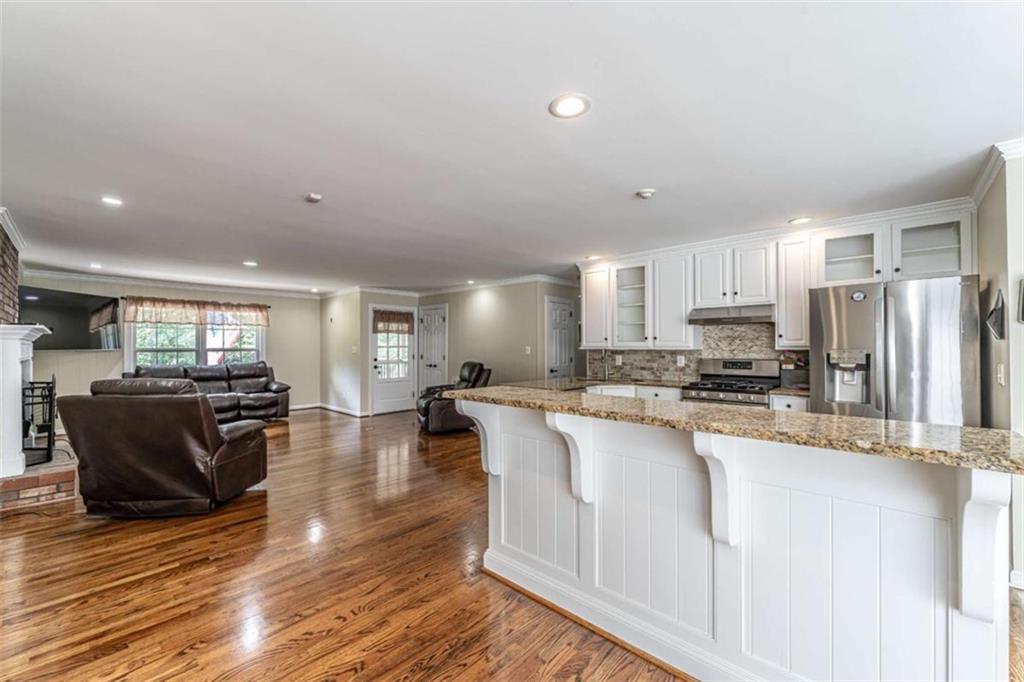 45 Wildflower Road Northeast Rome, GA 30161 - Photo 14 of 36 a large white kitchen with lots of counter space and stainless steel appliances