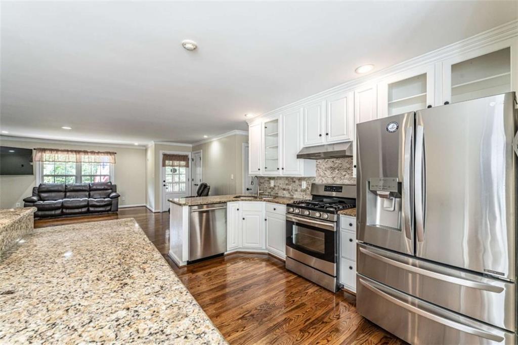 45 Wildflower Road Northeast Rome, GA 30161 - Photo 15 of 36 a kitchen with granite countertop stainless steel appliances a refrigerator stove top oven and sink