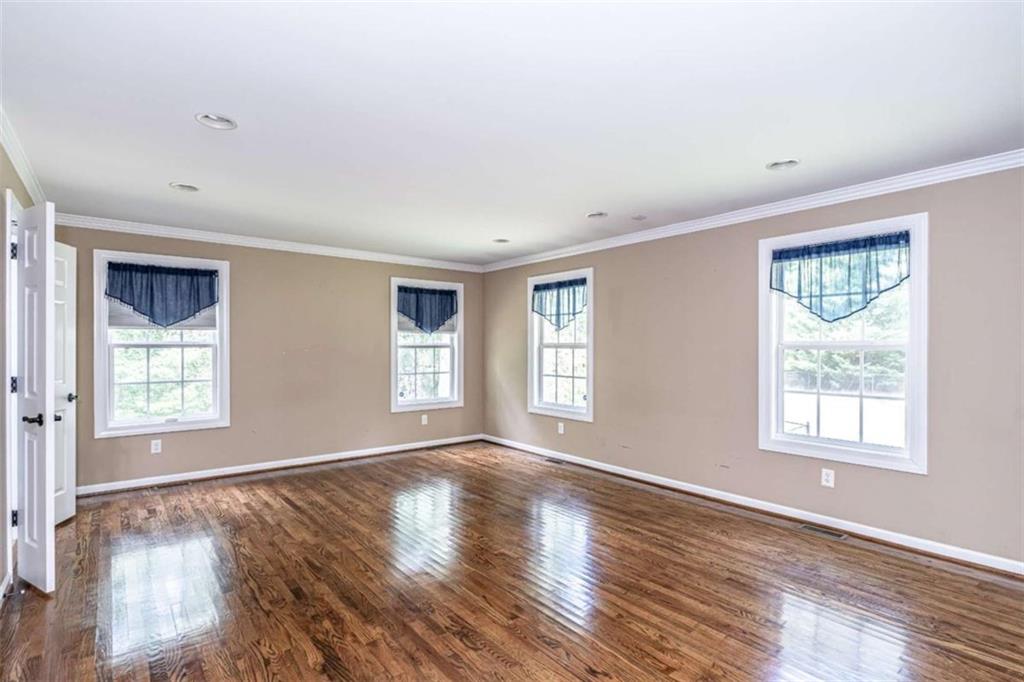 45 Wildflower Road Northeast Rome, GA 30161 - Photo 18 of 36 a view of an empty room with wooden floor and a window