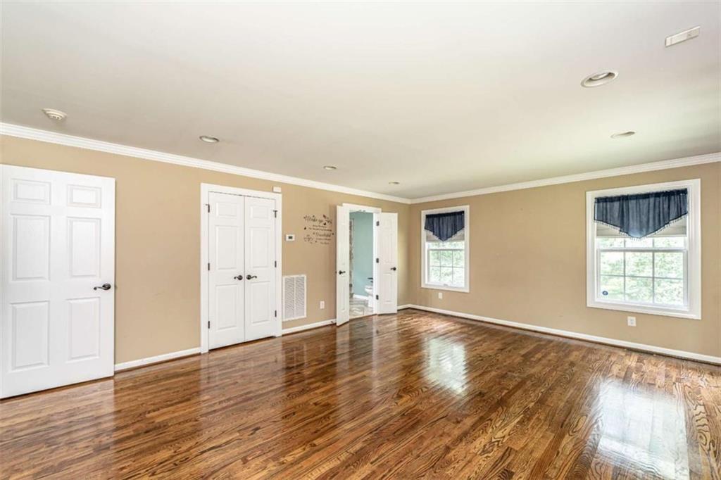 45 Wildflower Road Northeast Rome, GA 30161 - Photo 19 of 36 an empty room with wooden floor and windows