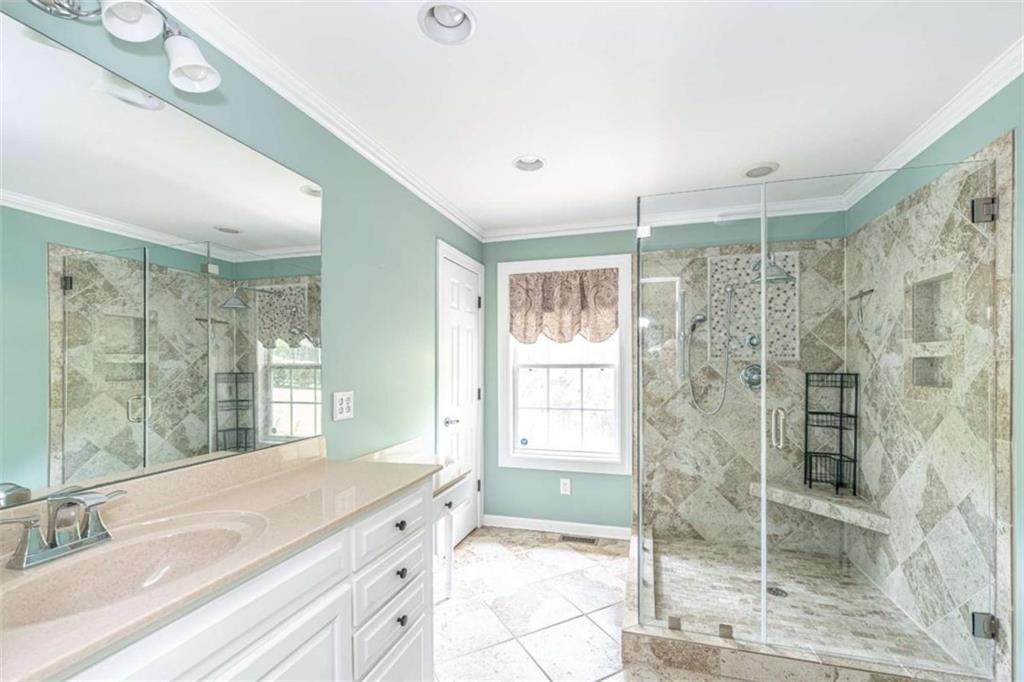 45 Wildflower Road Northeast Rome, GA 30161 - Photo 20 of 36 a spacious bathroom with a shower sink and mirror