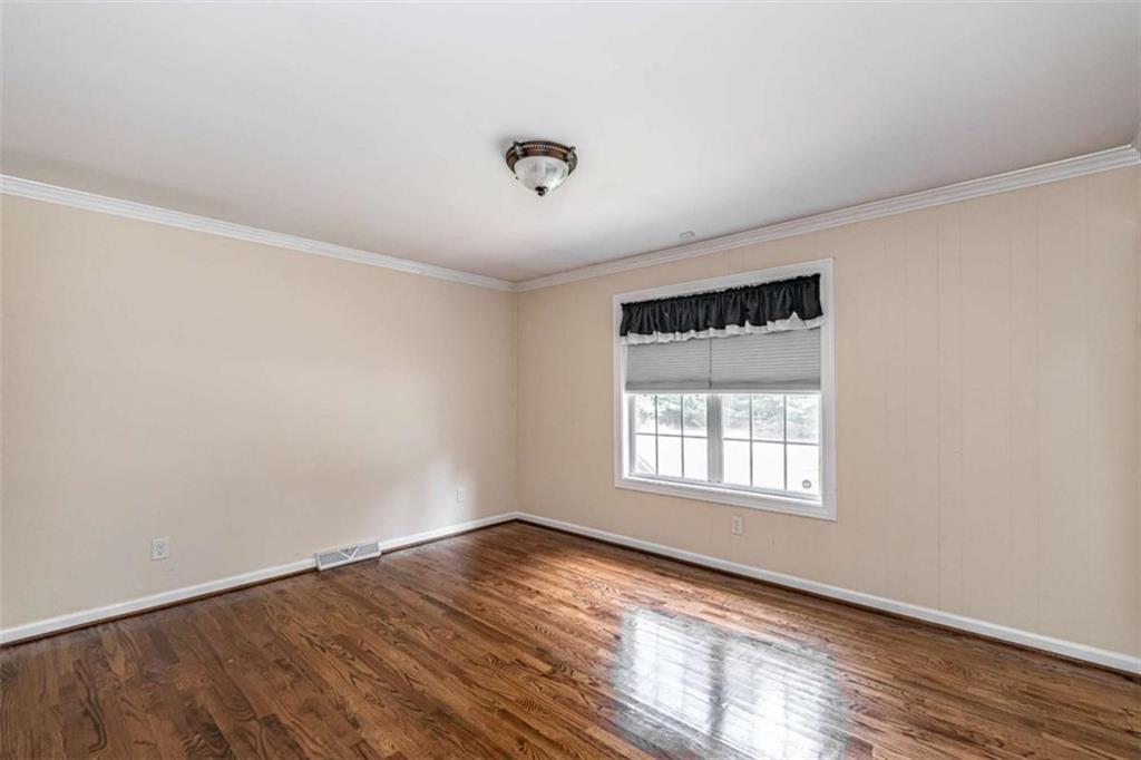 45 Wildflower Road Northeast Rome, GA 30161 - Photo 29 of 36 an empty room with wooden floor and windows