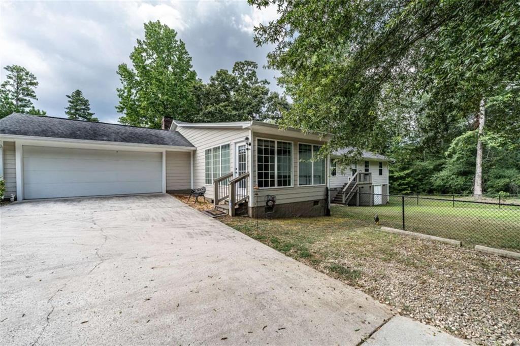 45 Wildflower Road Northeast Rome, GA 30161 - Photo 6 of 36 a view of a house with a yard and a garage