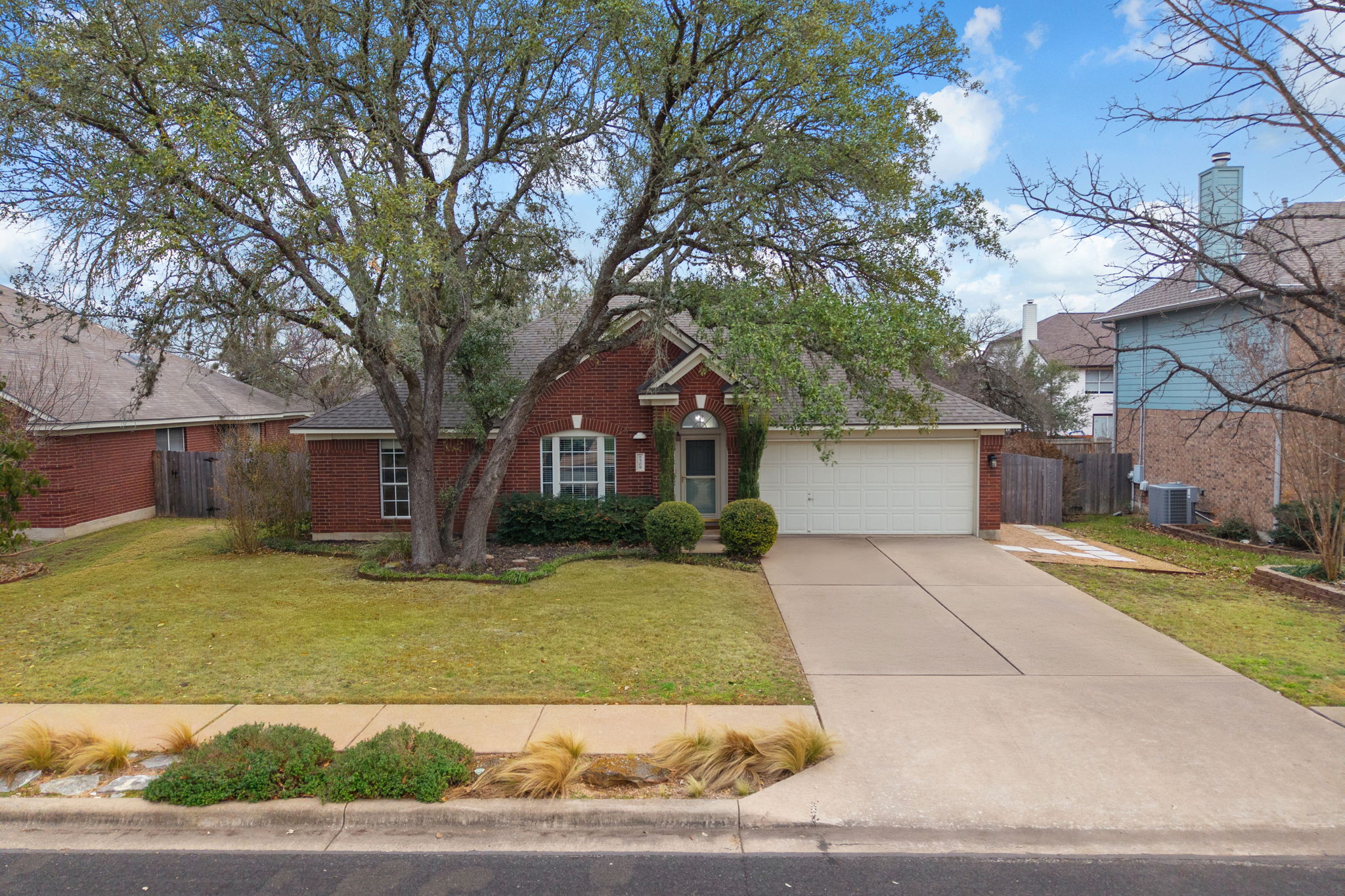 8509 Moose Cove Austin, TX 78749 - Photo 1 of 40 a front view of a house with a yard and garage