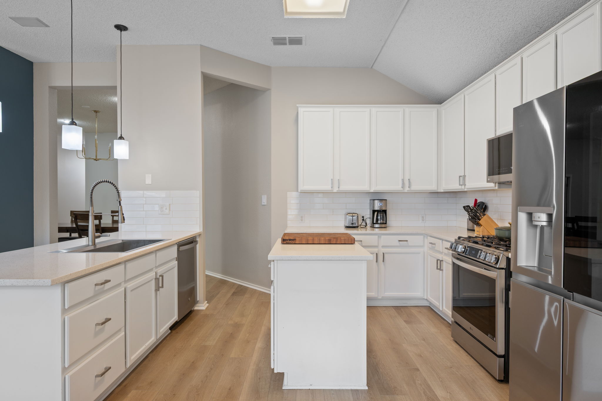 8509 Moose Cove Austin, TX 78749 - Photo 12 of 40 a kitchen with white cabinets and stainless steel appliances
