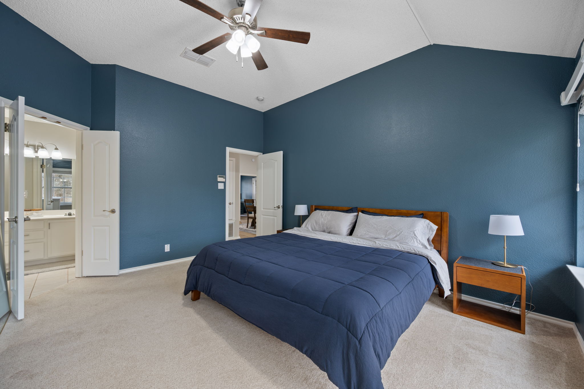 8509 Moose Cove Austin, TX 78749 - Photo 21 of 40 a bedroom with a bed and a chandelier
