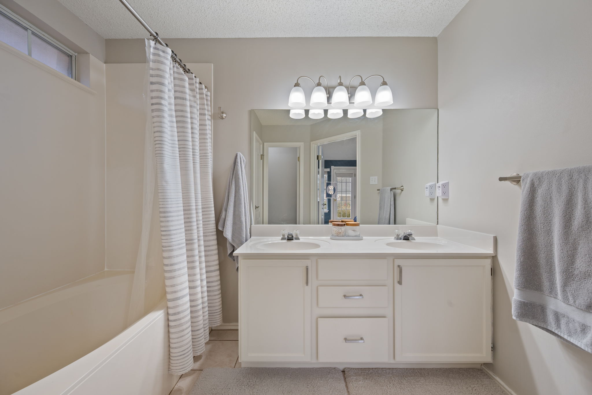 8509 Moose Cove Austin, TX 78749 - Photo 24 of 40 a hall with a sink and a mirror
