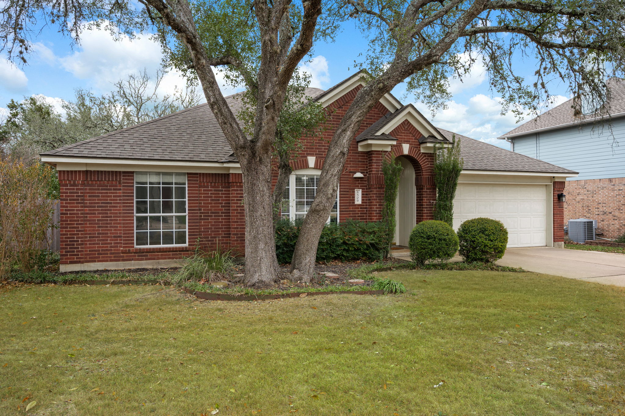 8509 Moose Cove Austin, TX 78749 - Photo 3 of 40 a front view of a house with a yard