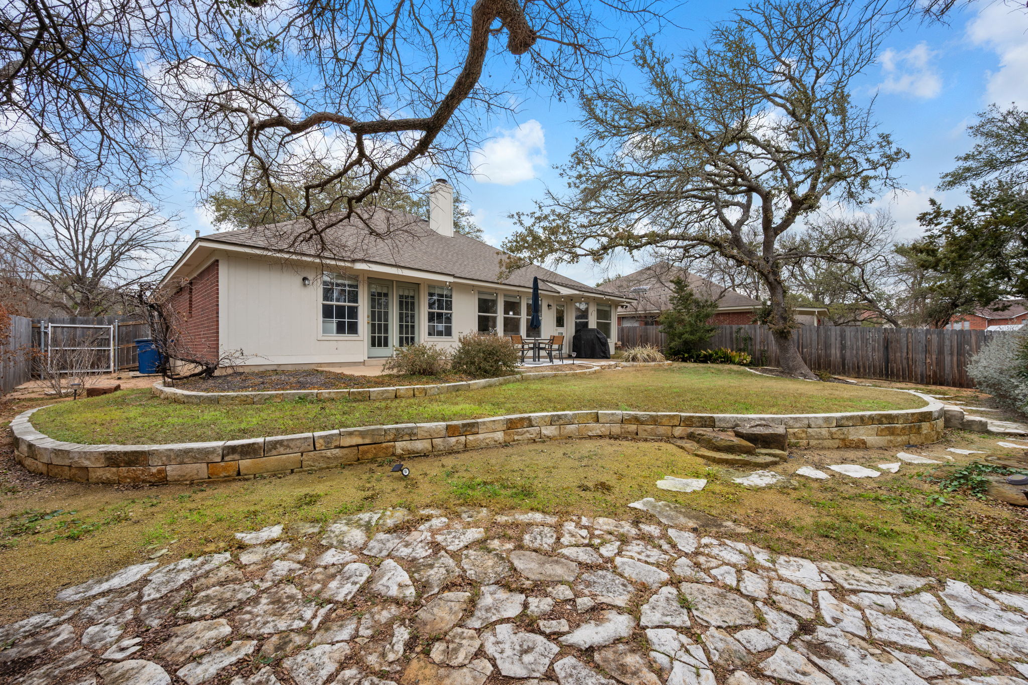 8509 Moose Cove Austin, TX 78749 - Photo 34 of 40 a front view of a house with a yard table and chairs