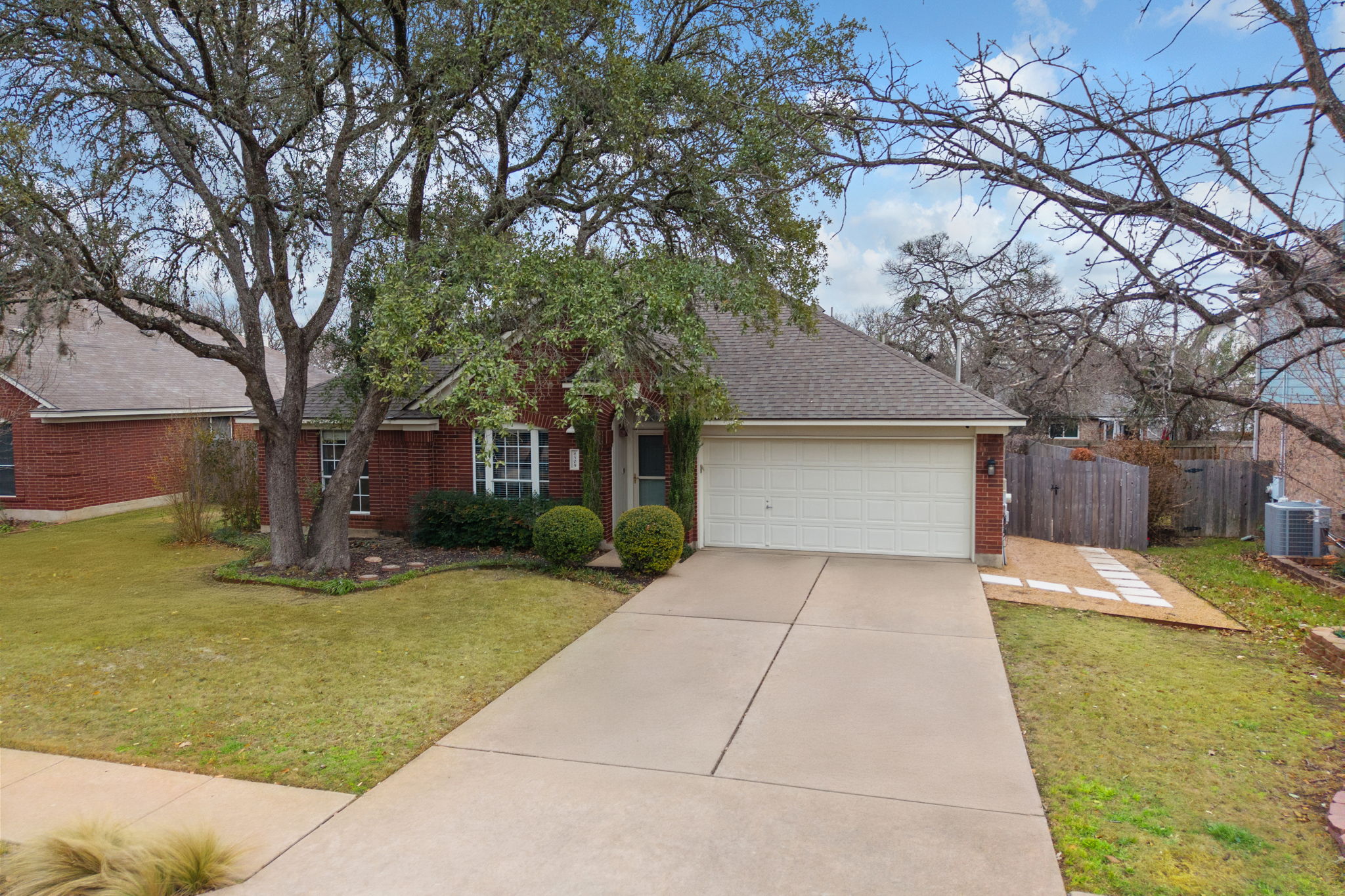8509 Moose Cove Austin, TX 78749 - Photo 37 of 40 a front view of a house with a yard garage and outdoor seating