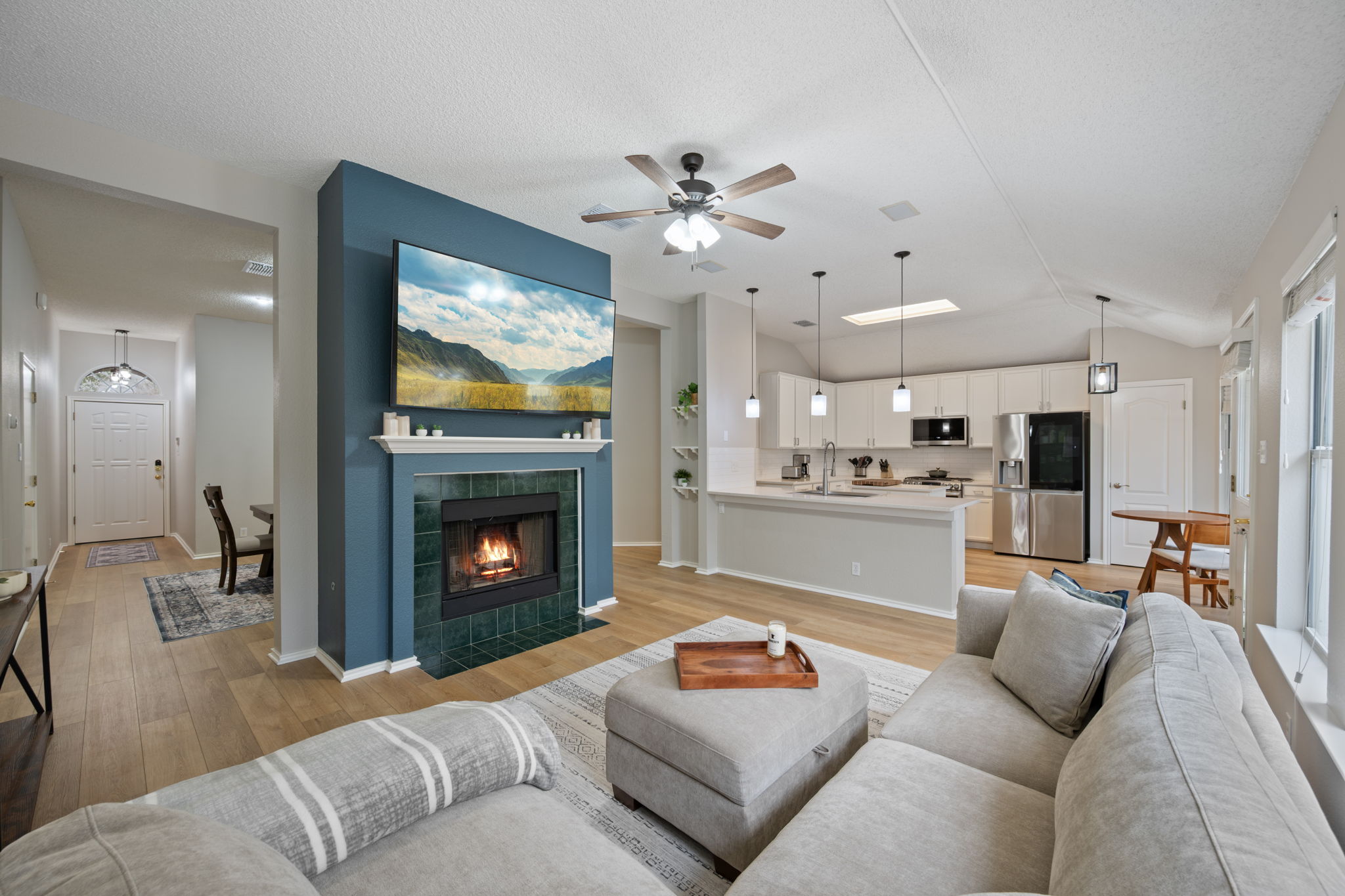 8509 Moose Cove Austin, TX 78749 - Photo 7 of 40 a living room with furniture a fireplace and kitchen view