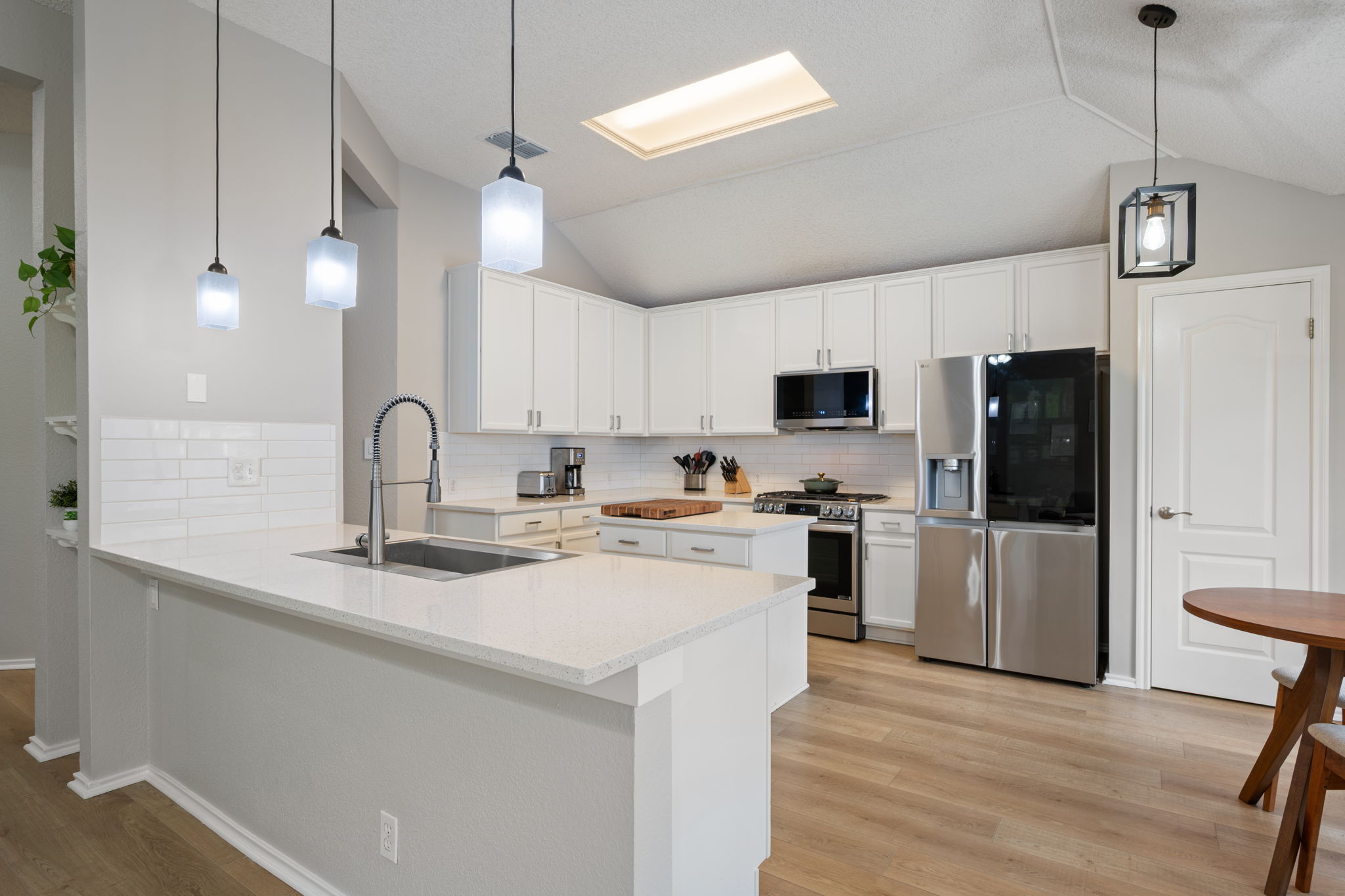8509 Moose Cove Austin, TX 78749 - Photo 10 of 40 a kitchen with a sink stainless steel appliances a refrigerator and cabinets