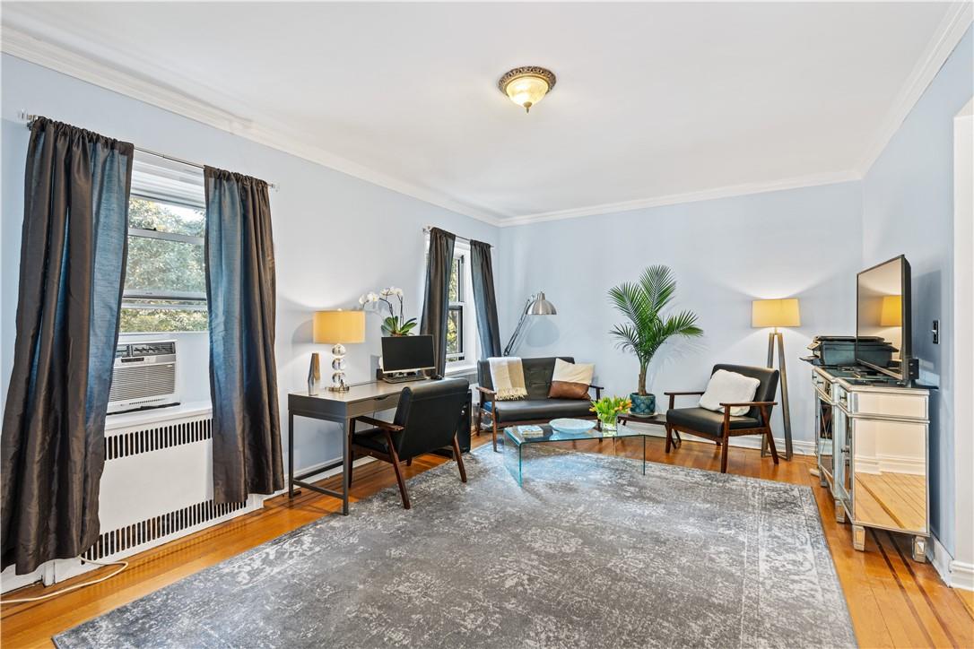 a living room with furniture stove and large window