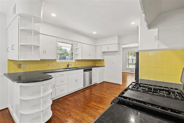 a kitchen with sink refrigerator and stove