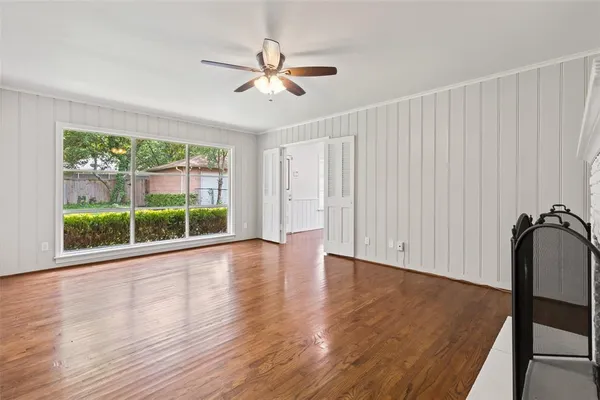 wooden floor in an empty room with a window