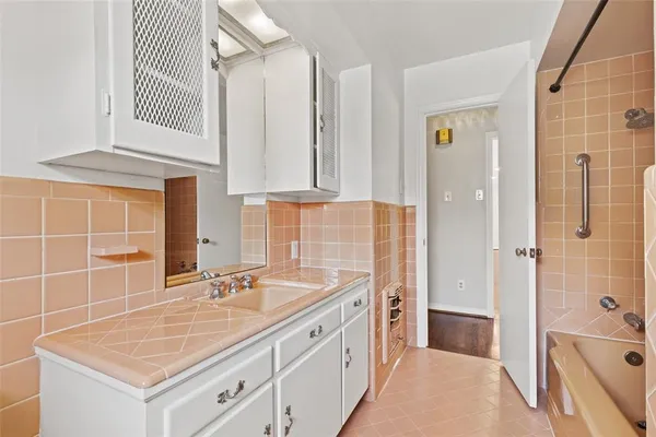 a bathroom with a sink double vanity and a shower