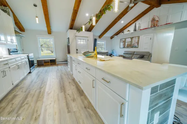 a large white kitchen with a large window