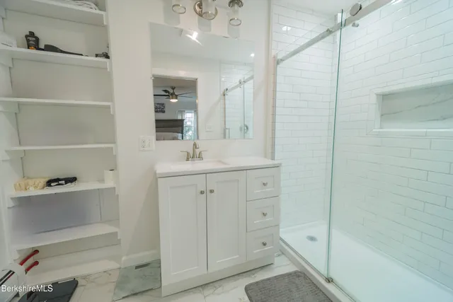 a bedroom with a bed and a large window