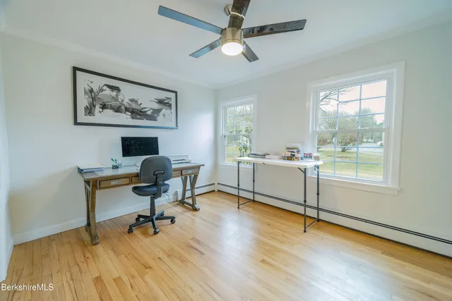 a spacious bedroom with a bed and a wooden floor