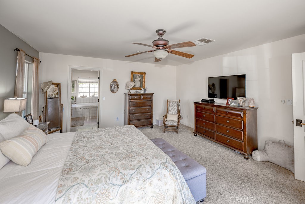 34554 Koontz Road Agua Dulce, CA 91390 - Photo 12 of 33 a spacious bedroom with a bed and a flat screen tv