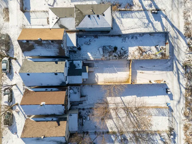 an aerial view of a house with a swimming pool