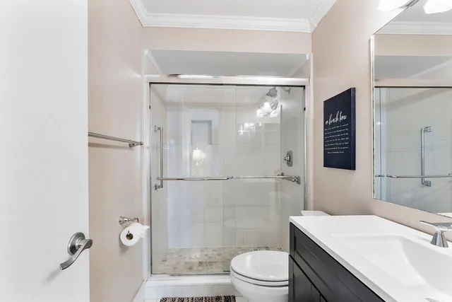 a bedroom with a balcony a bed and a large window