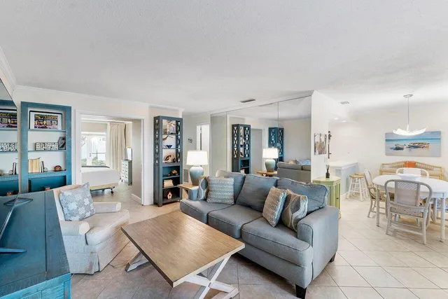 a living room with furniture a flat screen tv and a large window
