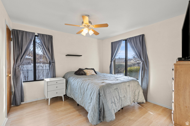 320 North 150 West Logan, UT 84321 - Photo 10 of 22 Bedroom featuring light wood-style floors, a ceiling fan, and multiple windows
