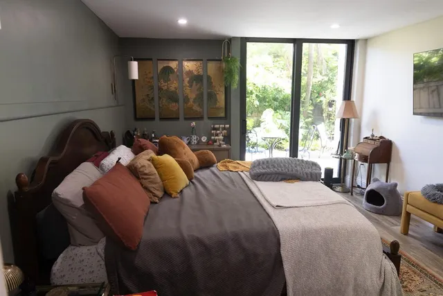 a bedroom with bed and wooden floor