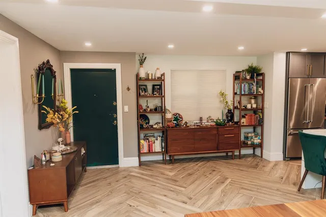 a kitchen with stainless steel appliances a sink and white cabinets