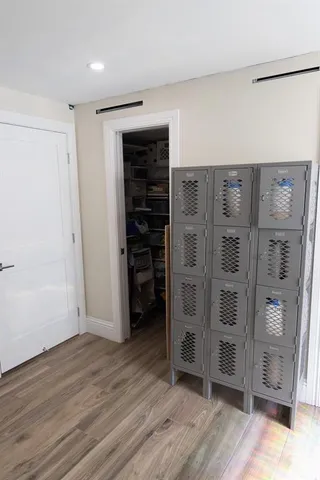 a view of walk in closet with wooden floor