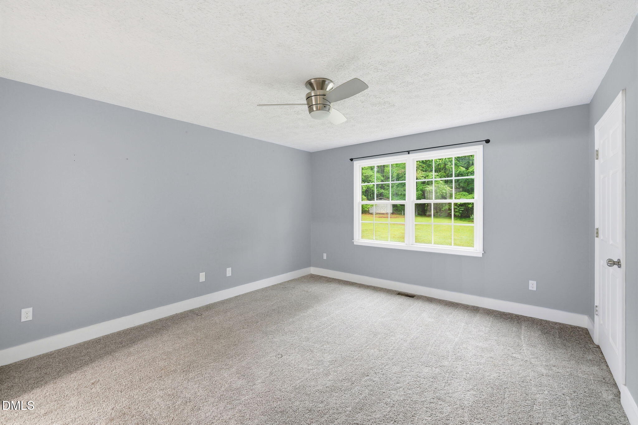 1925 Old Allensville Road Roxboro, NC 27574 - Photo 44 of 58 an empty room with windows and a ceiling fan